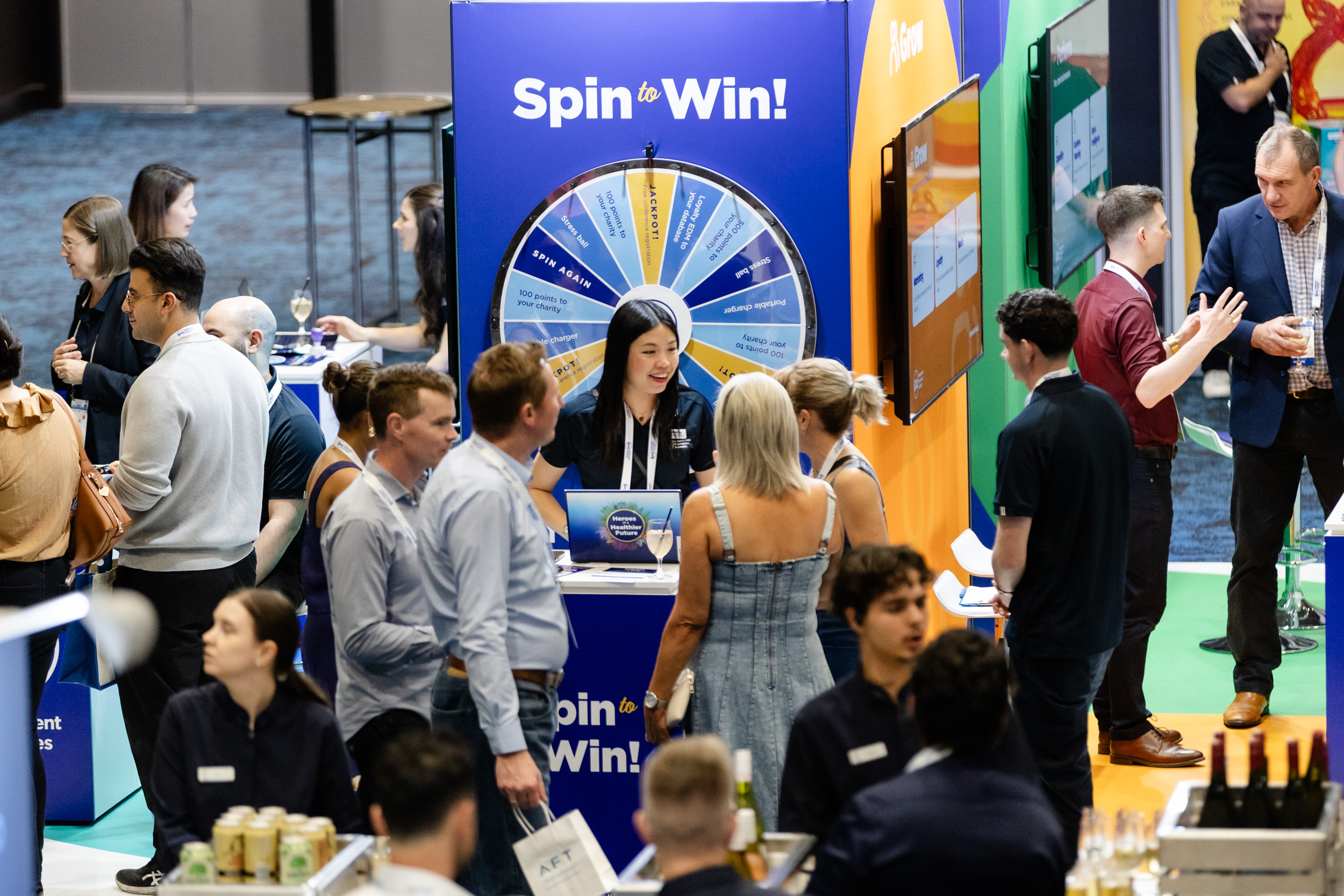 A delegate spinning the Spin to Win wheel at a sponsor booth