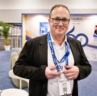 A delegate showing the medal earned through the passport