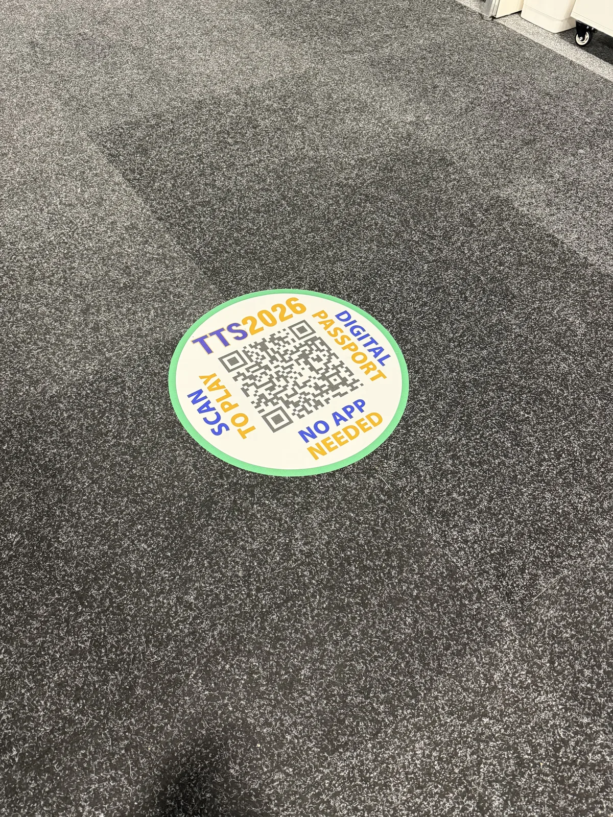 A passport QR floor decal on the exhibit hall floor